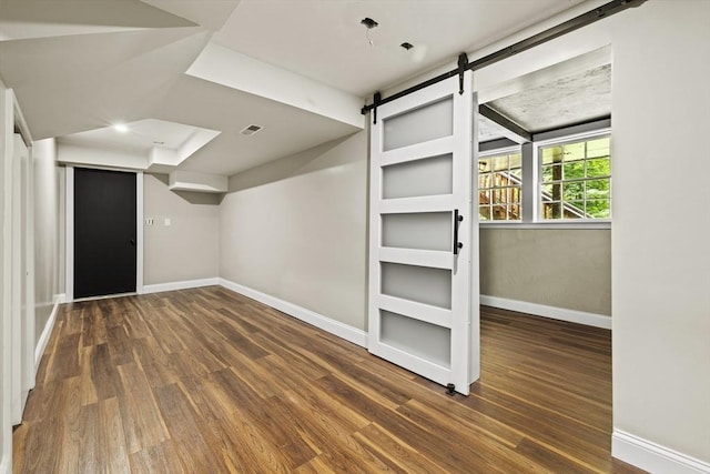 616 Grove St, Framingham, MA 01701 - basement with wood finished floors and a barn door
