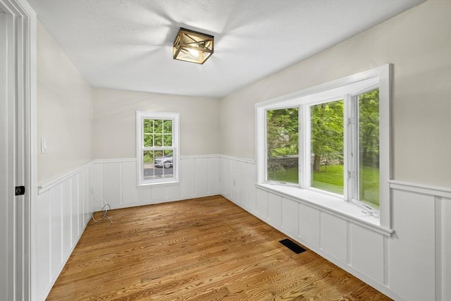 616 Grove St, Framingham, MA 01701 - spare room featuring wainscoting and light wood-style flooring
