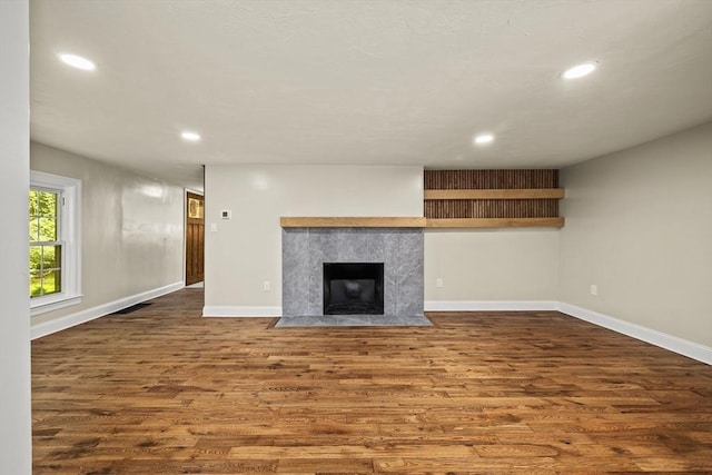 616 Grove St, Framingham, MA 01701 - unfurnished living room featuring wood finished floors, recessed lighting, and a premium fireplace