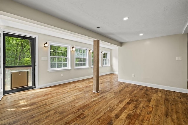 616 Grove St, Framingham, MA 01701 - empty room with wood finished floors, plenty of natural light, and recessed lighting