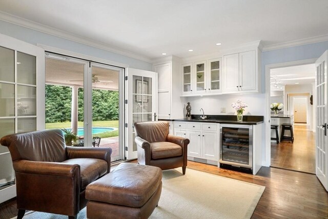 10 Queen Anne Rd, Hopkinton, MA 01748 - bar with beverage cooler, indoor wet bar, wood finished floors, and crown molding