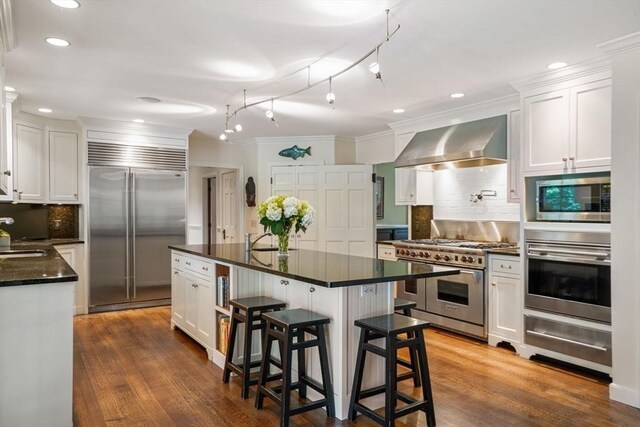 10 Queen Anne Rd, Hopkinton, MA 01748 - kitchen with white cabinets, a warming drawer, wall chimney exhaust hood, and high quality appliances