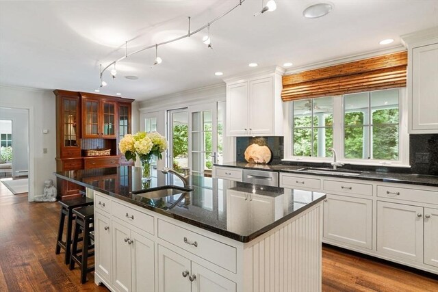 10 Queen Anne Rd, Hopkinton, MA 01748 - kitchen featuring decorative backsplash, dark wood-style flooring, a sink, and an island with sink