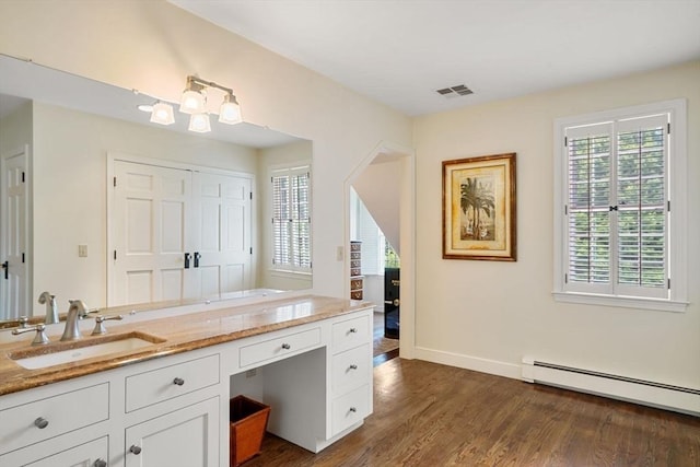 10 Queen Anne Rd, Hopkinton, MA 01748 - bathroom featuring baseboards, visible vents, a baseboard radiator, wood finished floors, and vanity