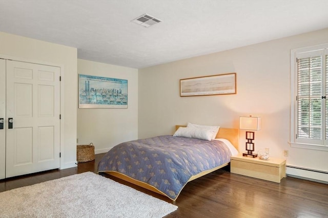 10 Queen Anne Rd, Hopkinton, MA 01748 - bedroom with a baseboard radiator, visible vents, baseboards, and wood finished floors