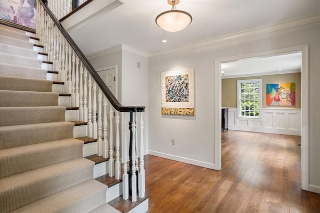 10 Queen Anne Rd, Hopkinton, MA 01748 - entryway with baseboards, wainscoting, wood-type flooring, stairs, and crown molding