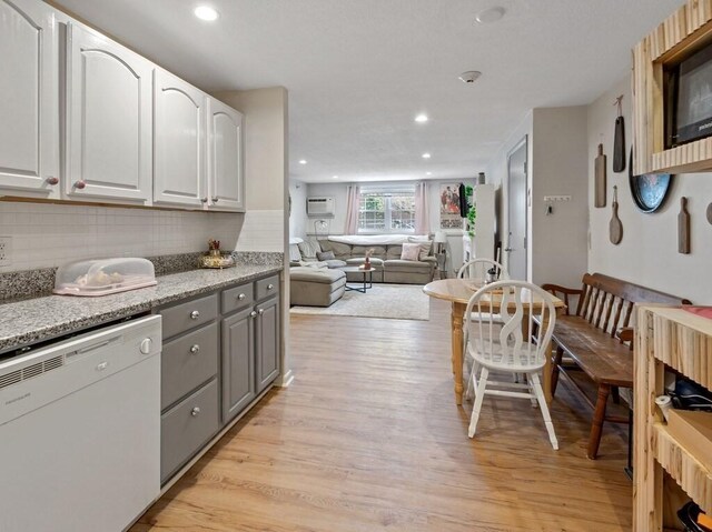 kitchen featuring white dishwasher, gray cabinets, light wood-style floors, decorative backsplash, and recessed lighting