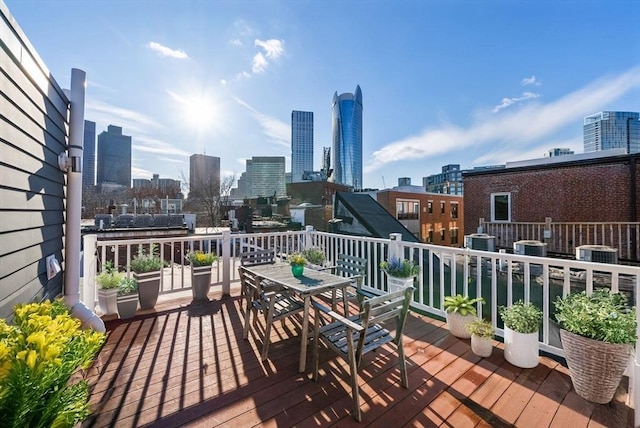 deck featuring a view of city and outdoor dining area