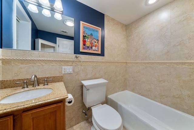 full bath with a tub to relax in, tile walls, visible vents, toilet, and vanity