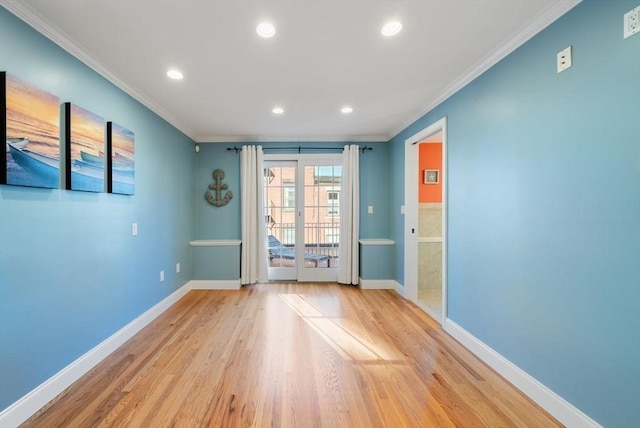 spare room with light wood finished floors, baseboards, ornamental molding, and recessed lighting