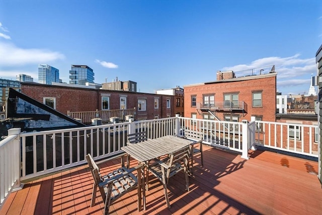 wooden deck featuring a city view