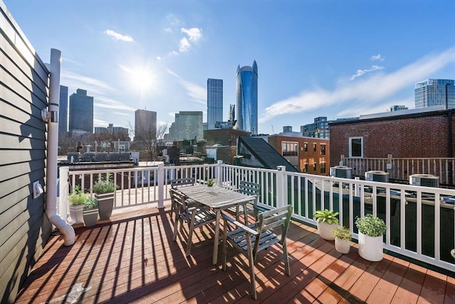 wooden deck with a view of city, central AC, and outdoor dining space