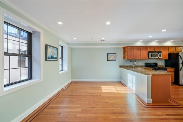 kitchen with brown cabinetry, a peninsula, light stone countertops, black appliances, and open shelves