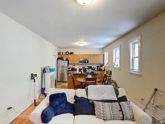 living area featuring baseboards