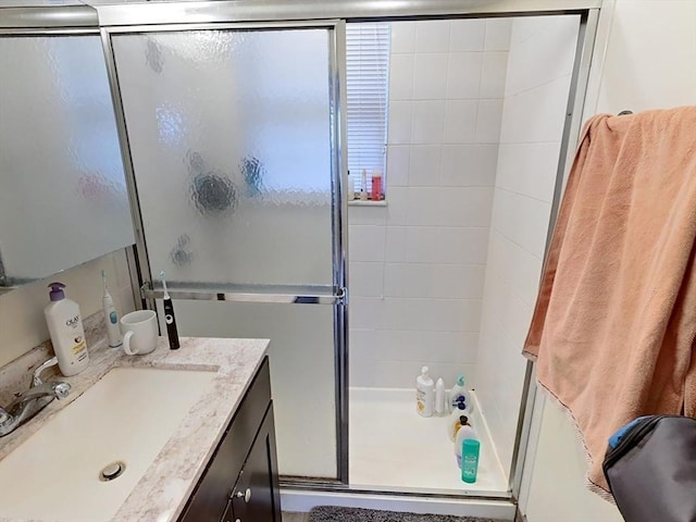 full bathroom with a shower stall and vanity