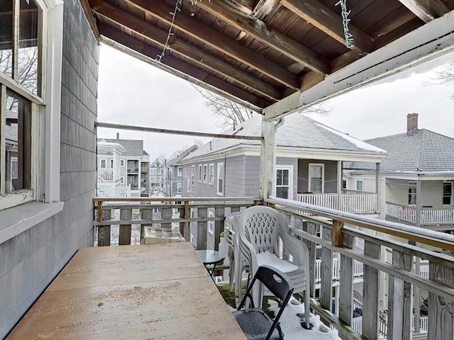 balcony with outdoor dining area and a residential view