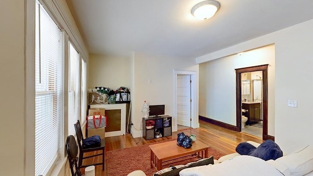 living room featuring light wood-type flooring and baseboards