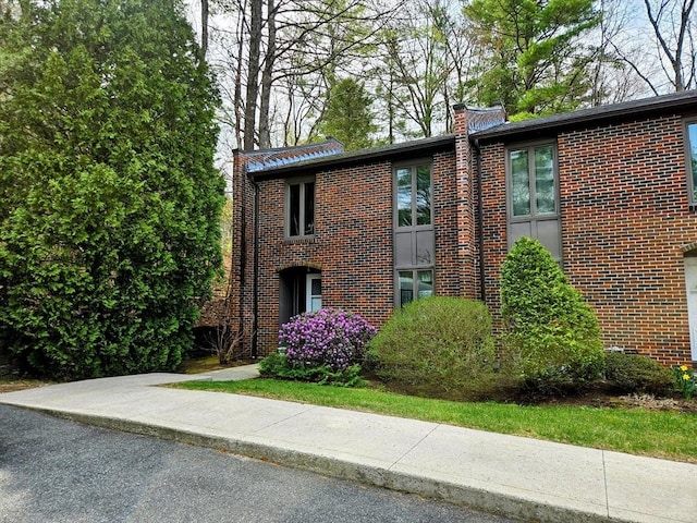12 Chadwick Ct Unit 12, Amherst, MA 01002 - view of side of home with brick siding and a chimney