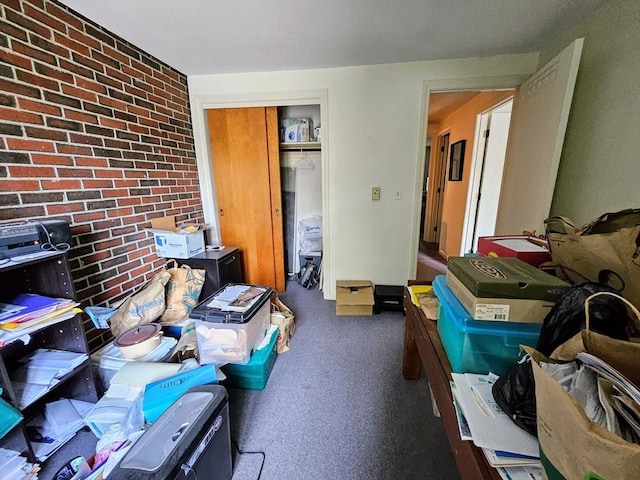 12 Chadwick Ct Unit 12, Amherst, MA 01002 - bedroom with brick wall, a closet, and carpet floors