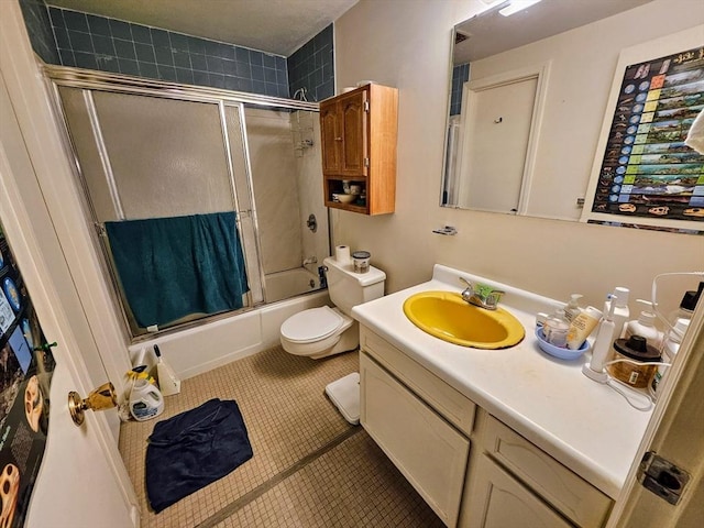 12 Chadwick Ct Unit 12, Amherst, MA 01002 - bathroom with bath / shower combo with glass door, vanity, tile patterned flooring, and toilet