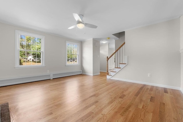 unfurnished living room with ceiling fan, light wood-type flooring, crown molding, and a baseboard radiator