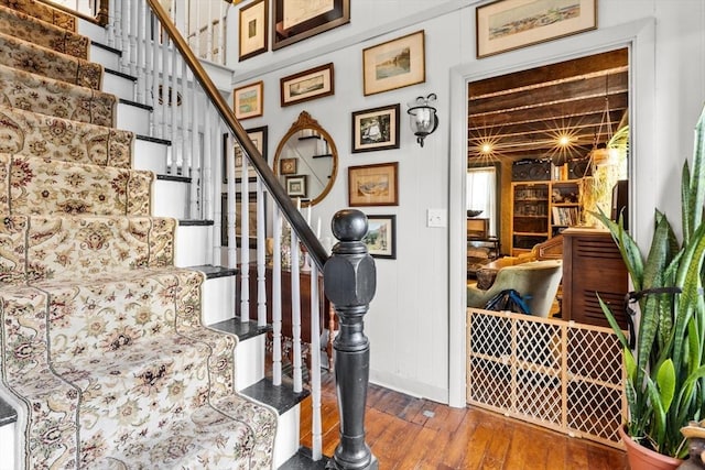 stairs with wood-type flooring and baseboards