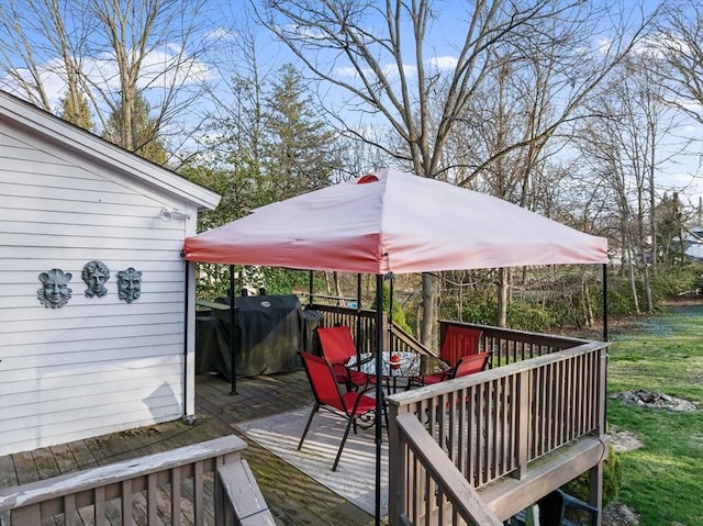 deck with grilling area and outdoor dining area