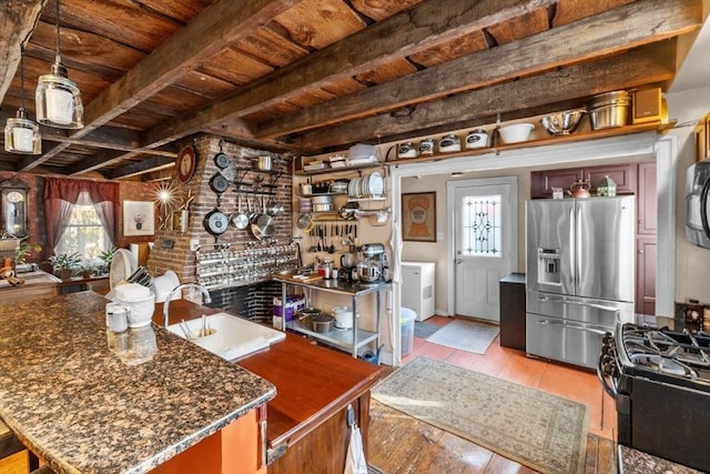kitchen with black range with gas stovetop, wooden ceiling, a sink, beam ceiling, and stainless steel refrigerator with ice dispenser