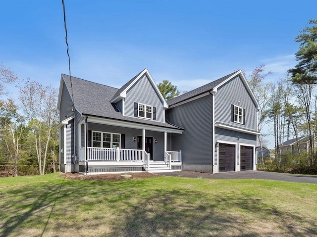 view of front of property with a garage, a front yard, covered porch, and driveway