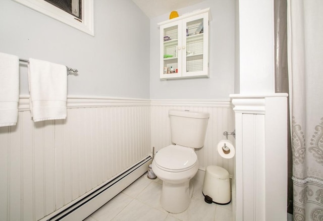 bathroom featuring tile patterned flooring, a baseboard radiator, and toilet