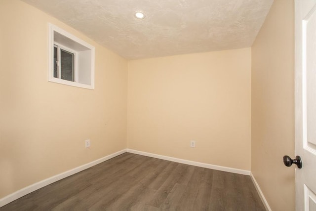 spare room with dark hardwood / wood-style flooring