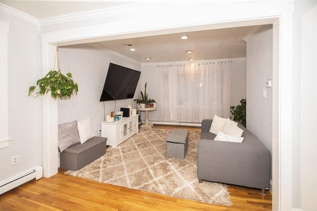 living room with crown molding, wood-type flooring, and a baseboard heating unit