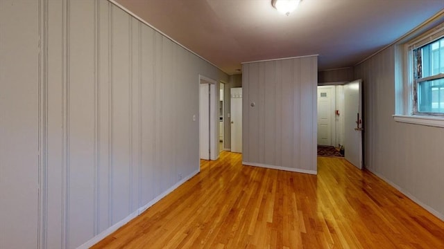 unfurnished room featuring light wood-style floors and baseboards