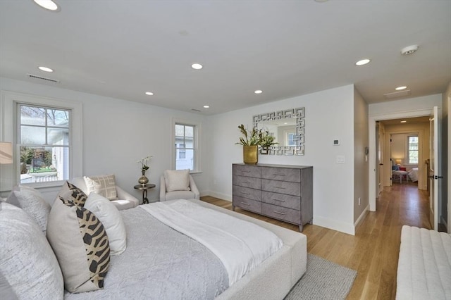 bedroom featuring baseboards, wood finished floors, and recessed lighting