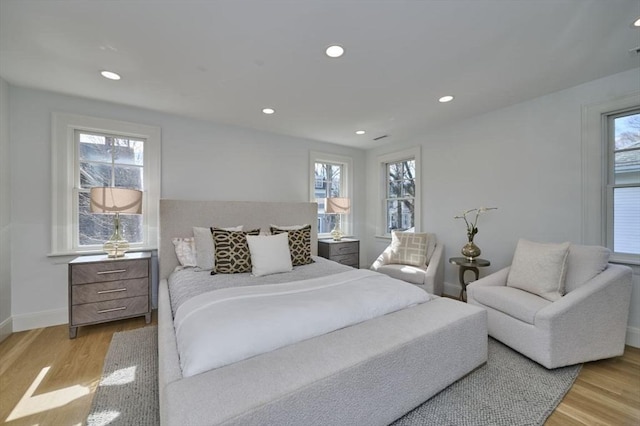 bedroom with recessed lighting, baseboards, and wood finished floors