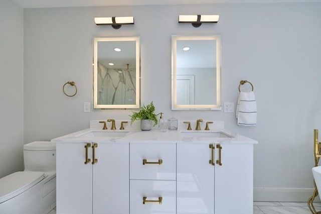 full bathroom featuring marble finish floor, baseboards, a sink, and toilet