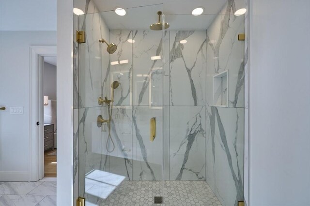 bathroom featuring marble finish floor and a marble finish shower