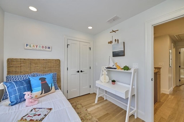 bedroom featuring light wood-style floors, attic access, visible vents, and recessed lighting