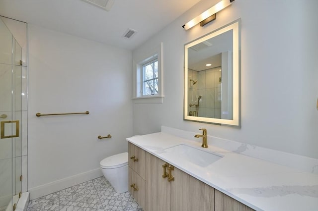 bathroom with toilet, vanity, visible vents, baseboards, and a stall shower