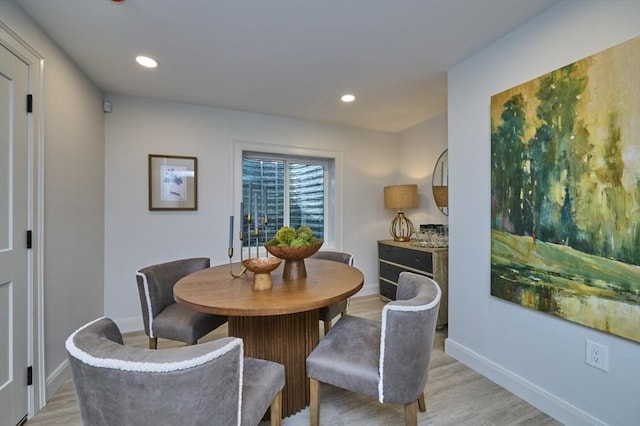 dining space with light wood finished floors, baseboards, and recessed lighting