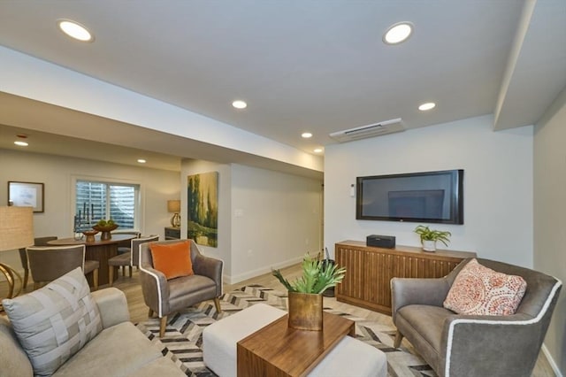 living area featuring baseboards, light wood-style floors, and recessed lighting