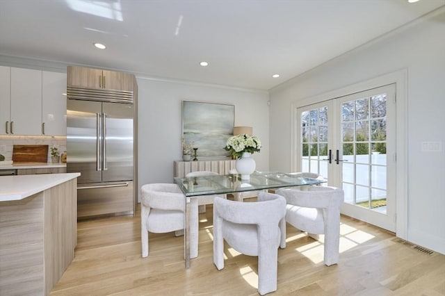 dining area with visible vents, radiator, light wood-style flooring, french doors, and recessed lighting