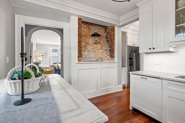 kitchen with crown molding, arched walkways, dark wood-style flooring, and high quality fridge