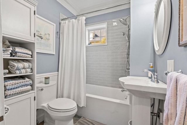 bathroom with crown molding, a wainscoted wall, toilet, and shower / bath combination with curtain