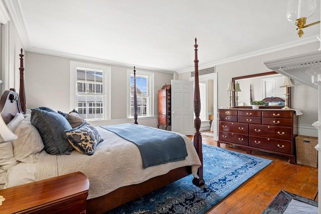 bedroom featuring wood-type flooring and ornamental molding