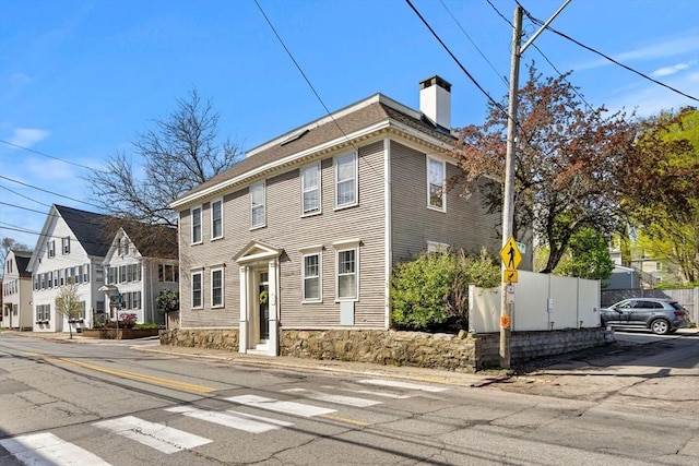 colonial-style house with a chimney