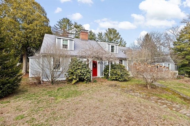 view of front of home with a front lawn and a chimney