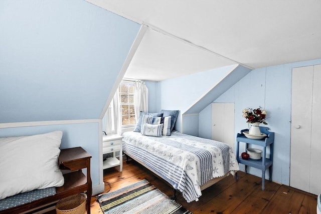 bedroom featuring lofted ceiling and hardwood / wood-style flooring