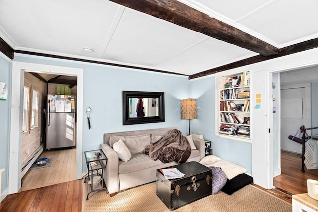 living room with built in features, hardwood / wood-style flooring, beamed ceiling, and baseboard heating
