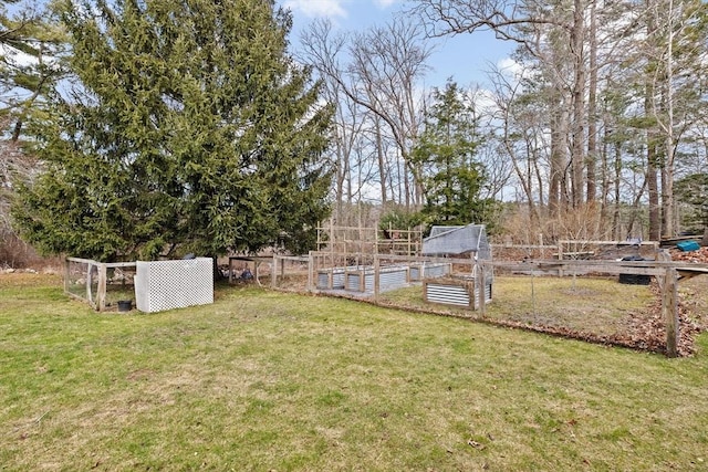 view of yard featuring fence and a garden